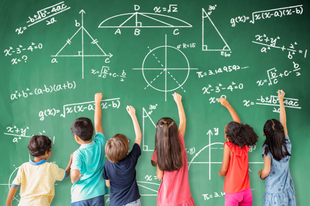 school children drawing math icon on the chalkboard